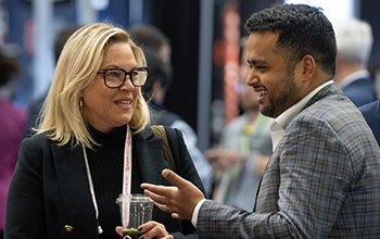 Two attendee share a laugh during MD&M Midwest