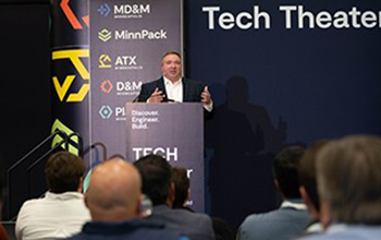 Attendees listen to the speaker on the Tech Theater stage