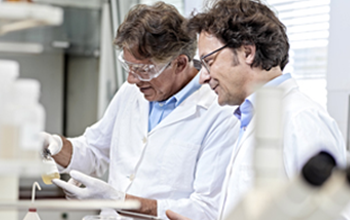 Two medical professionals inspect product