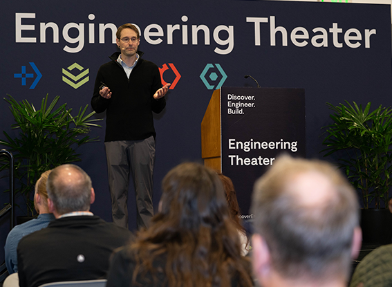 Attendees listen to the speaker on the Engineering Theater stage