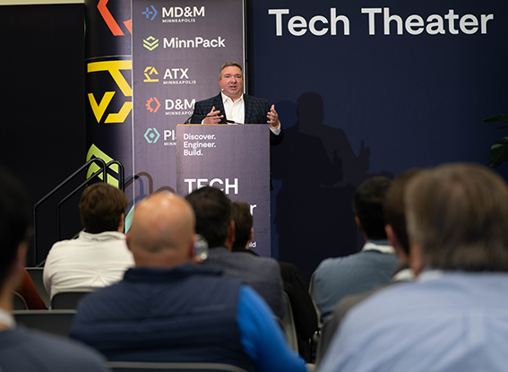 Attendees listen to the speaker on the Tech Theater stage