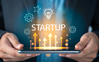 Man holds an image that says Startup