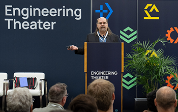 Speaker addresses a crowd on the Engineering Theater stage