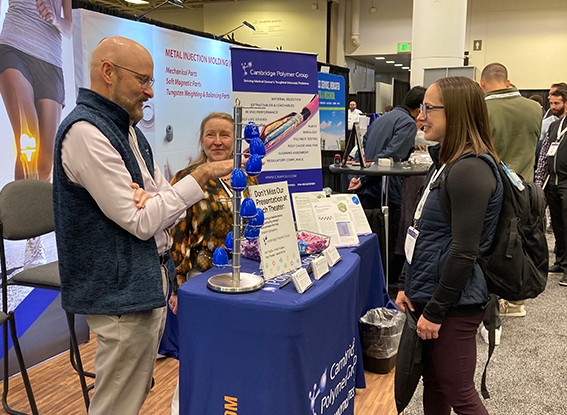 Attendee speaks to exhibitor about his products