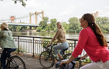 Women bike outdoors in Minneapolis “Four Seasons Hotel Minneapolis - Courtesy of Meet Minneapolis”